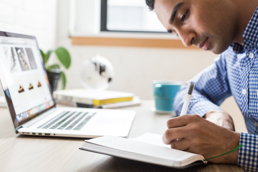 Man writing copy for his business's website.